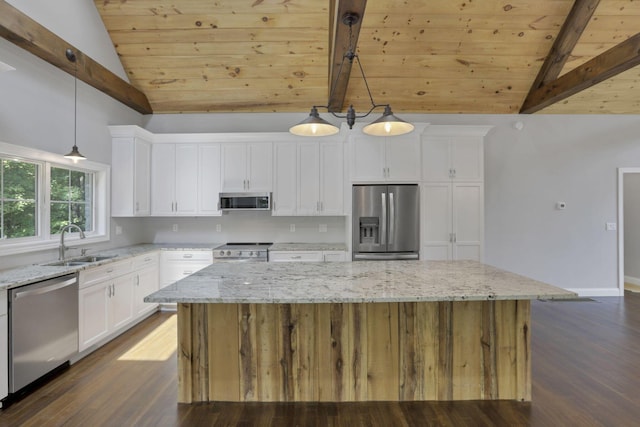 kitchen featuring pendant lighting, a kitchen island, and appliances with stainless steel finishes