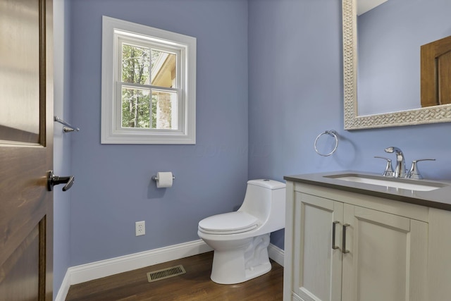 bathroom featuring hardwood / wood-style floors, vanity, and toilet