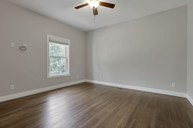 spare room featuring dark hardwood / wood-style floors and ceiling fan