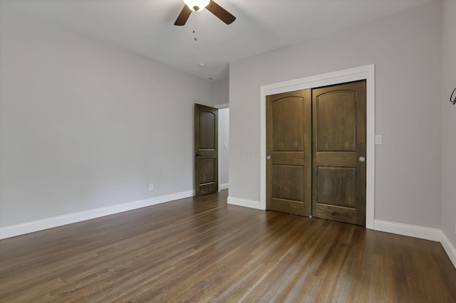 unfurnished bedroom with a closet, hardwood / wood-style flooring, and ceiling fan