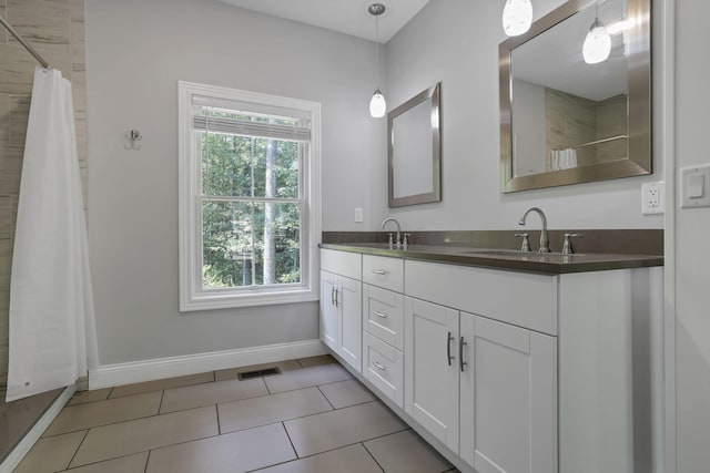 bathroom featuring tile patterned flooring and vanity