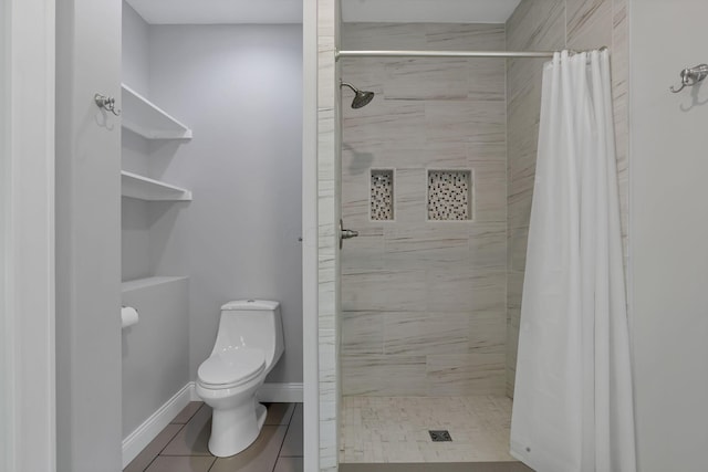 bathroom featuring toilet, tile patterned flooring, and a shower with shower curtain