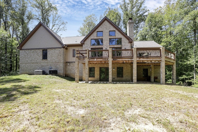 back of property featuring a lawn, cooling unit, and a wooden deck