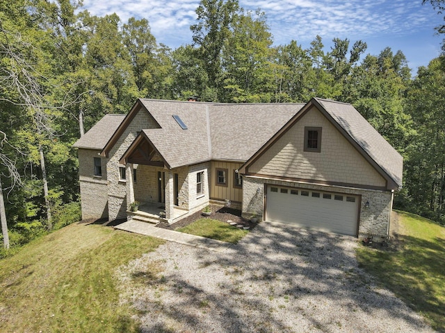 view of front of home with a front lawn, covered porch, and a garage