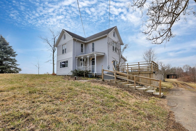 view of home's exterior with covered porch and a yard