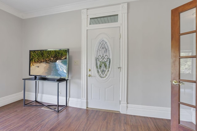 foyer featuring wood-type flooring, ornamental molding, and a wealth of natural light