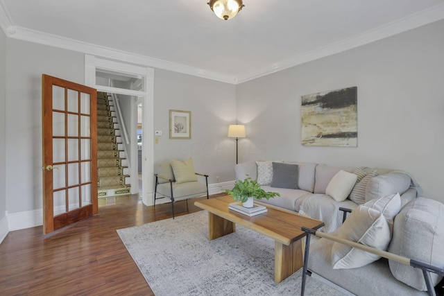 living room with dark hardwood / wood-style flooring and crown molding