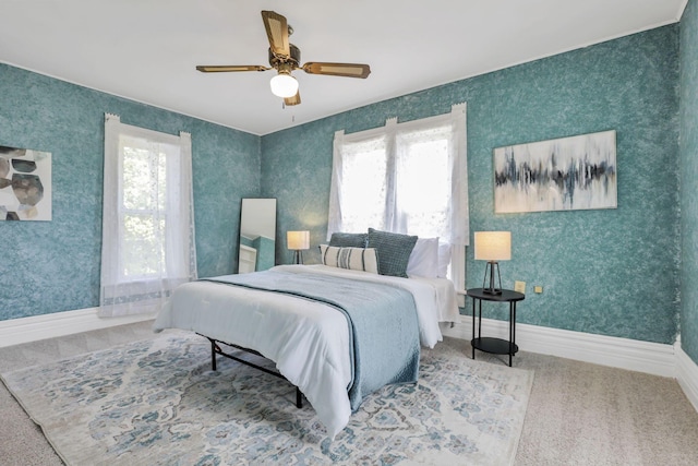 carpeted bedroom with multiple windows and ceiling fan