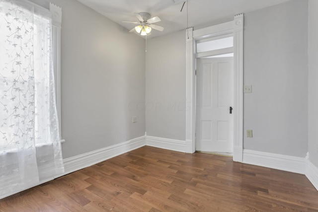 empty room featuring dark hardwood / wood-style floors and ceiling fan