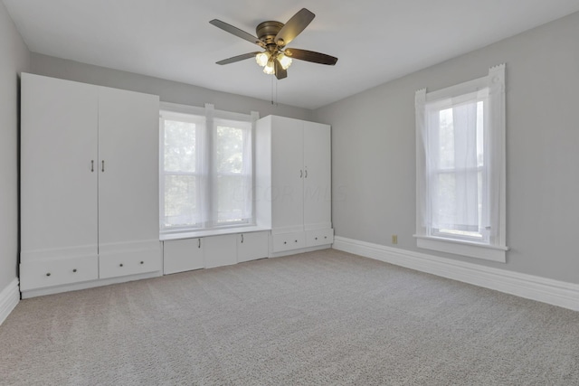 unfurnished bedroom with ceiling fan and light carpet