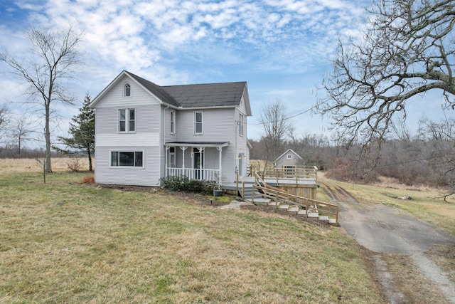 view of front of home featuring a porch and a front yard