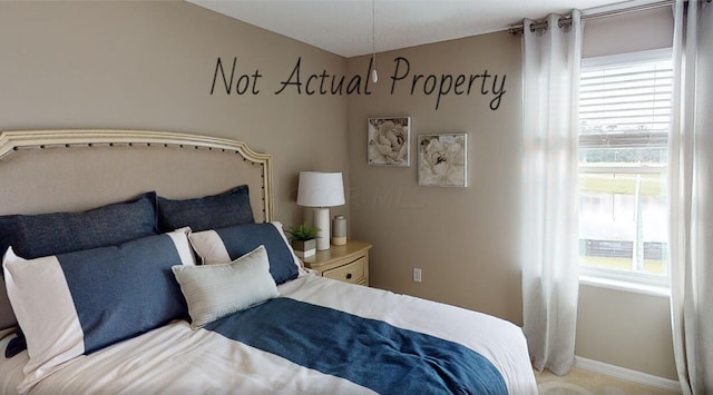 carpeted bedroom featuring multiple windows