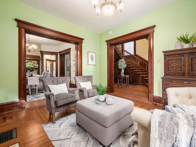 sitting room with light hardwood / wood-style floors and an inviting chandelier