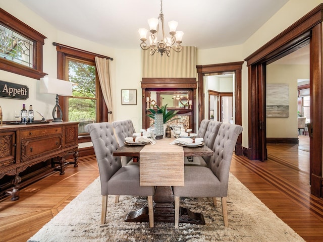 dining area featuring hardwood / wood-style flooring and a chandelier