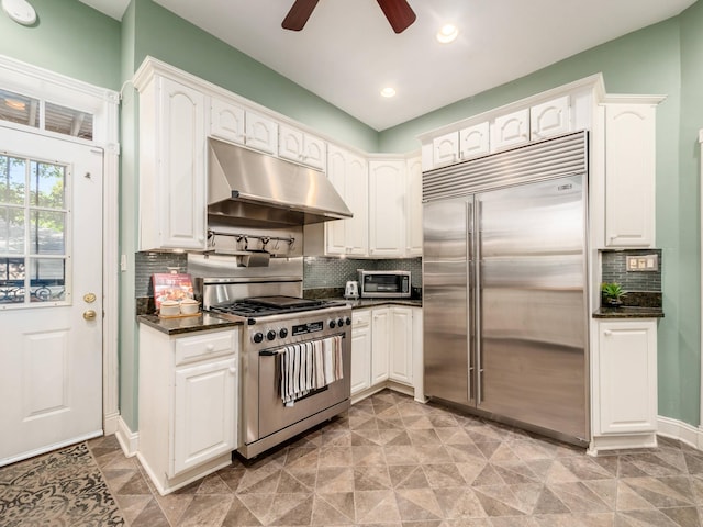43 Winner Ave, Columbus, OH 43203 - kitchen featuring appliances with stainless steel finishes, under cabinet range hood, ceiling fan, white cabinets, and backsplash