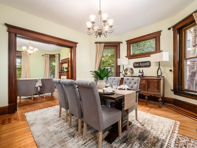 dining space featuring parquet flooring and an inviting chandelier