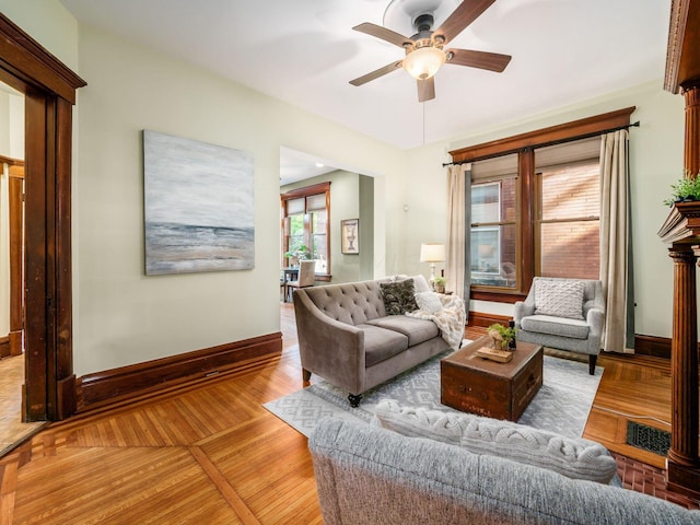 living room with light hardwood / wood-style floors and ceiling fan