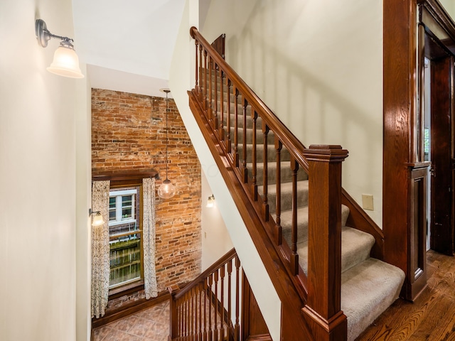 stairway with hardwood / wood-style floors