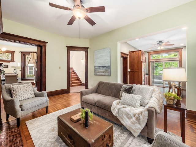 living room featuring ceiling fan and hardwood / wood-style floors