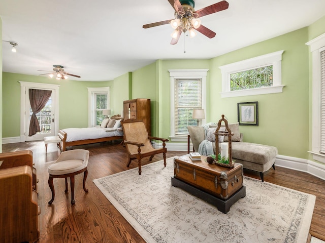 living area with ceiling fan and wood-type flooring