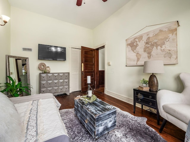 living room with dark hardwood / wood-style floors and ceiling fan