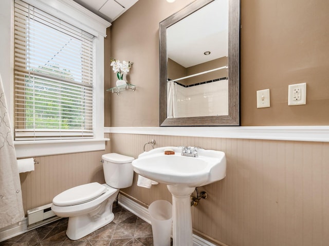 bathroom with wood walls, a baseboard heating unit, tile patterned flooring, toilet, and curtained shower