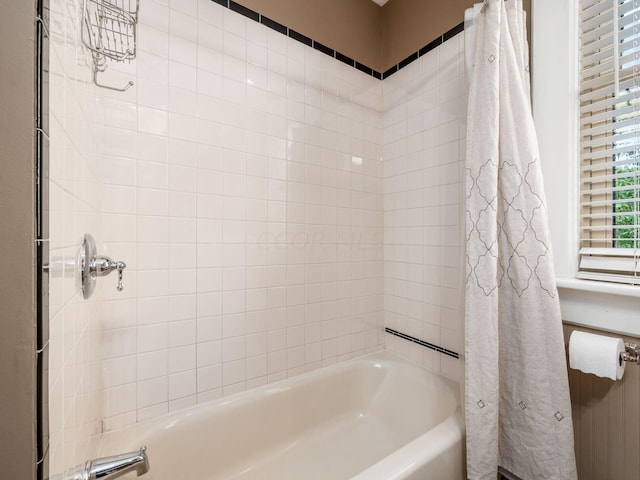 bathroom with shower / bathtub combination with curtain