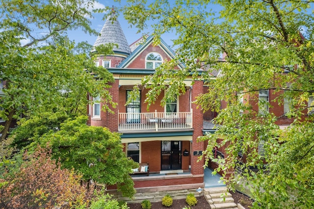 view of front of house featuring a balcony