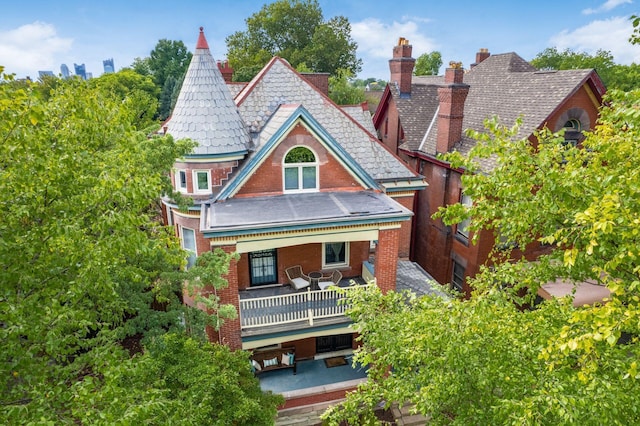 43 Winner Ave, Columbus, OH 43203 - rear view of house featuring a high end roof, a balcony, a chimney, and brick siding