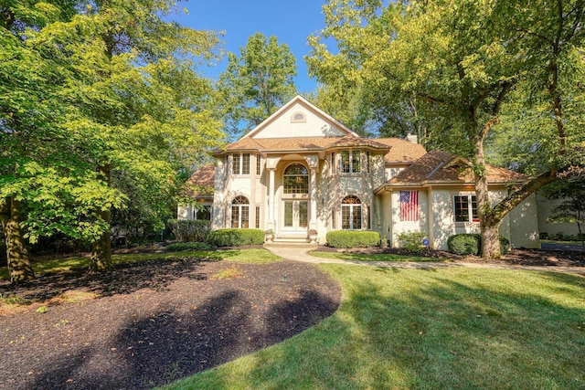 mediterranean / spanish-style house with a front yard