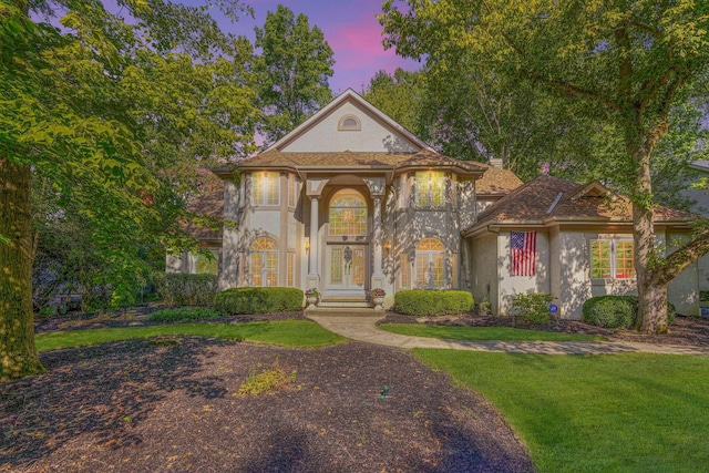 view of front of property featuring a yard and french doors