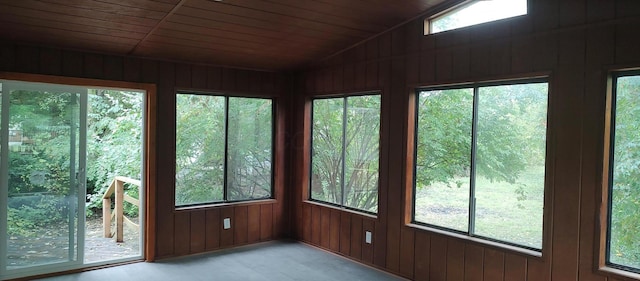 unfurnished sunroom with wood ceiling and vaulted ceiling