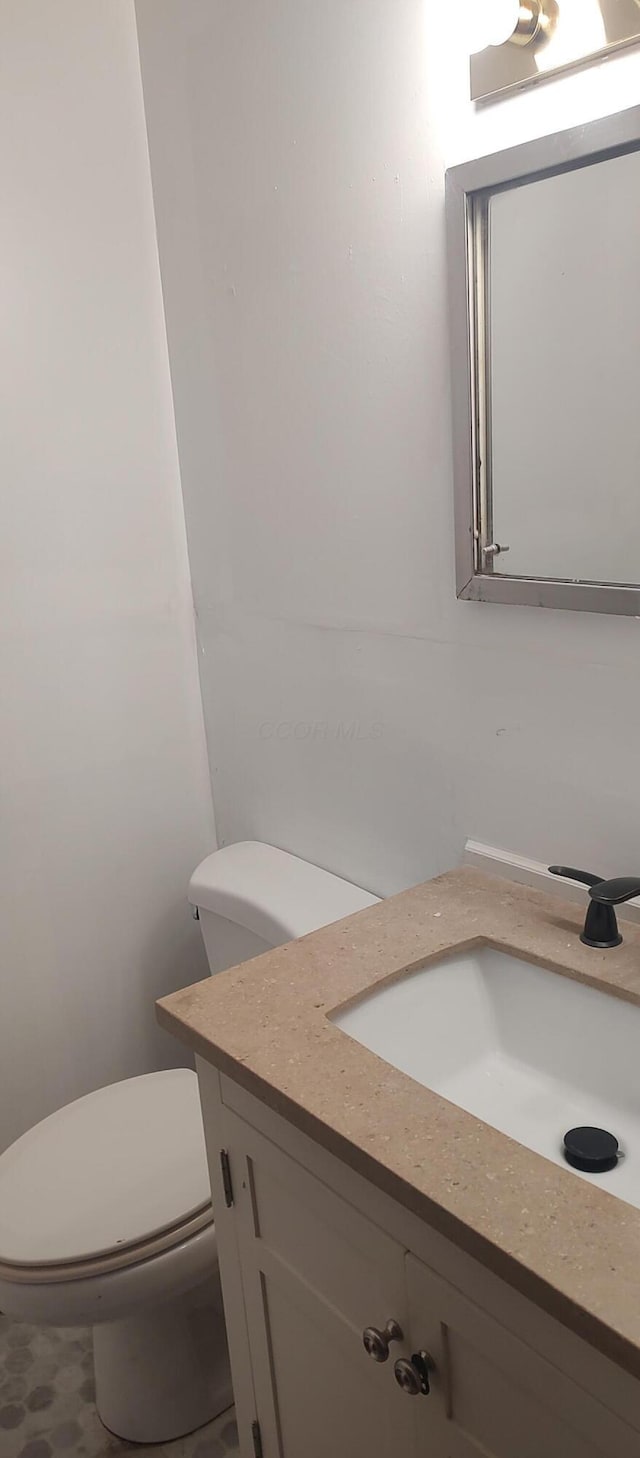 bathroom with vanity and toilet