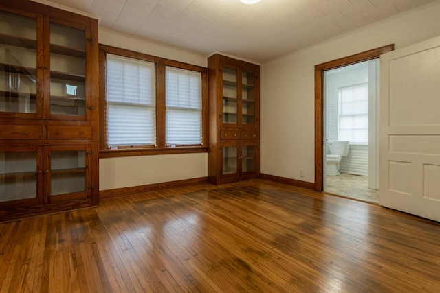 interior space featuring dark hardwood / wood-style floors and crown molding