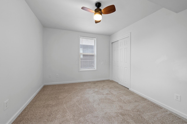 empty room with ceiling fan and light colored carpet