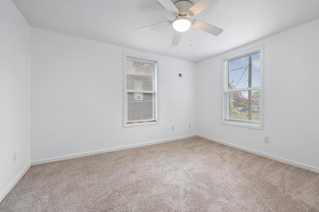 empty room featuring ceiling fan and carpet floors