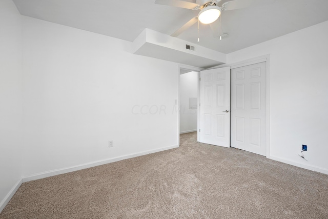 unfurnished bedroom featuring carpet, a closet, and ceiling fan