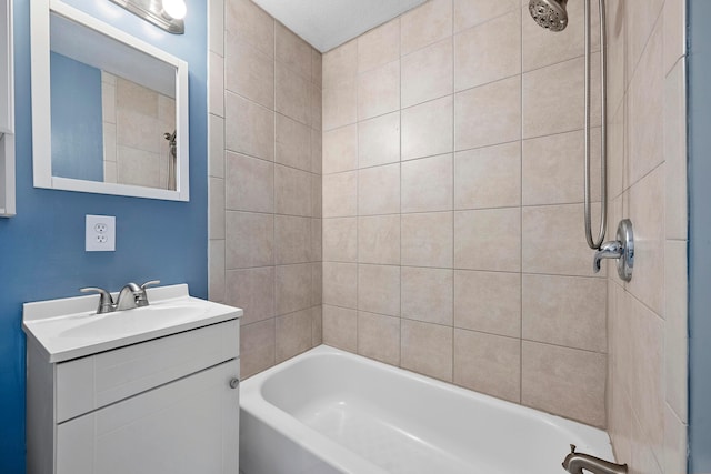 bathroom featuring vanity and tiled shower / bath combo