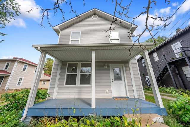 rear view of house with covered porch