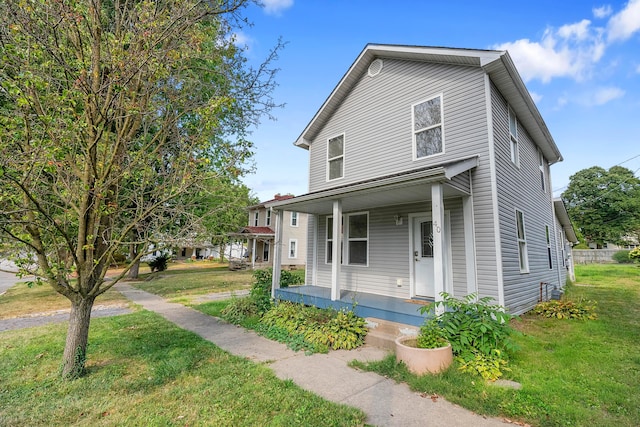 view of front of home with covered porch and a front yard