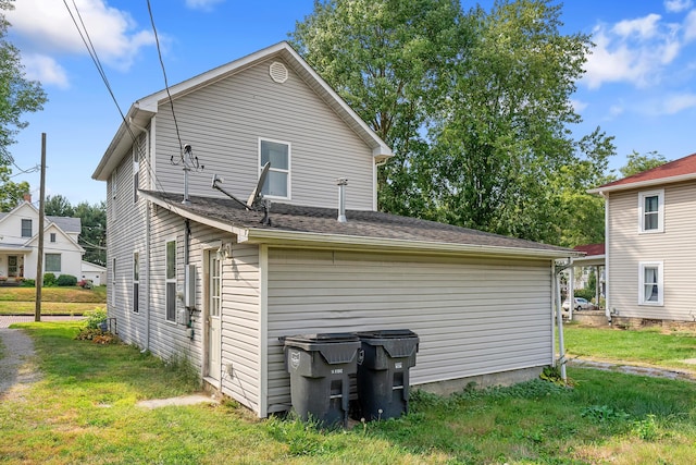 rear view of property with a lawn