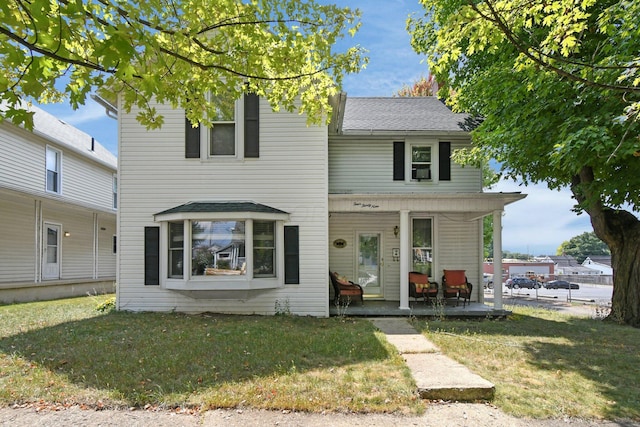 view of front facade with covered porch and a front yard