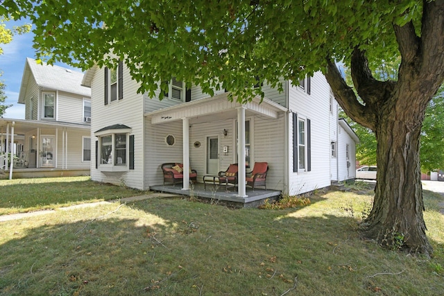 view of front of property with a porch and a front yard