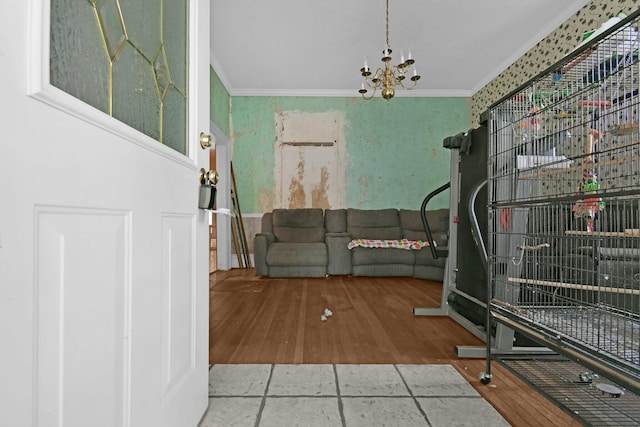 interior space with hardwood / wood-style flooring, a chandelier, and ornamental molding