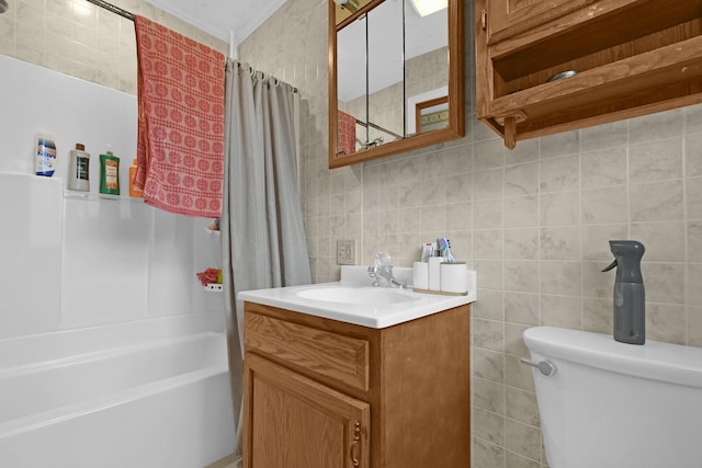 full bathroom with shower / bath combo, vanity, toilet, tile walls, and tasteful backsplash