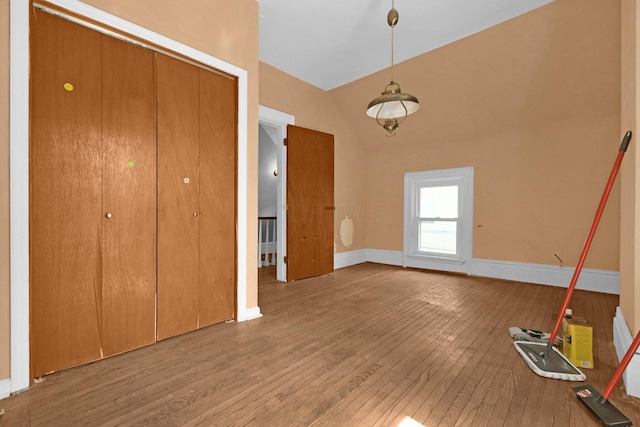 interior space featuring high vaulted ceiling and hardwood / wood-style flooring