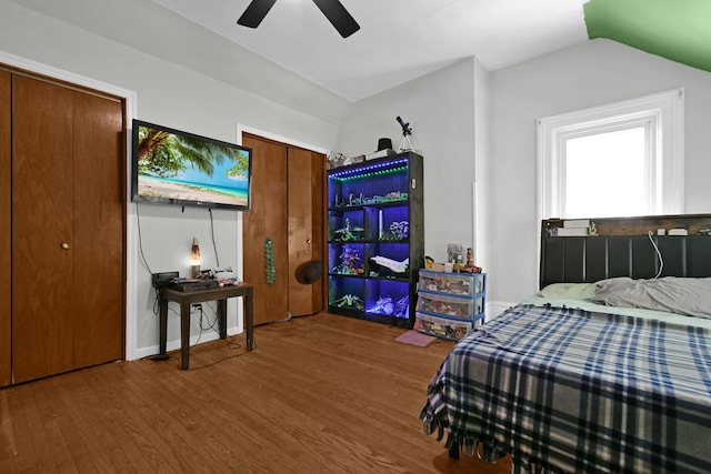 bedroom with hardwood / wood-style flooring, ceiling fan, and vaulted ceiling