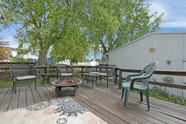 wooden terrace featuring a fire pit