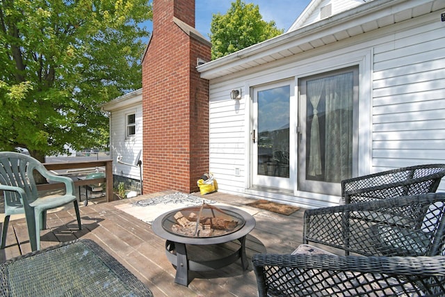 view of patio / terrace featuring a fire pit and a deck