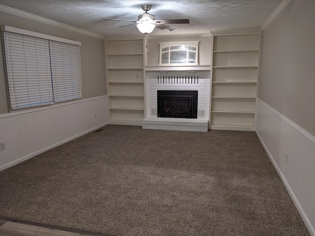 unfurnished living room featuring ornamental molding, a brick fireplace, carpet floors, and a textured ceiling